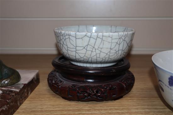 A Chinese crackle glaze bowl, early 20th century blue and white bowl and a wood stand largest diameter 17cm
